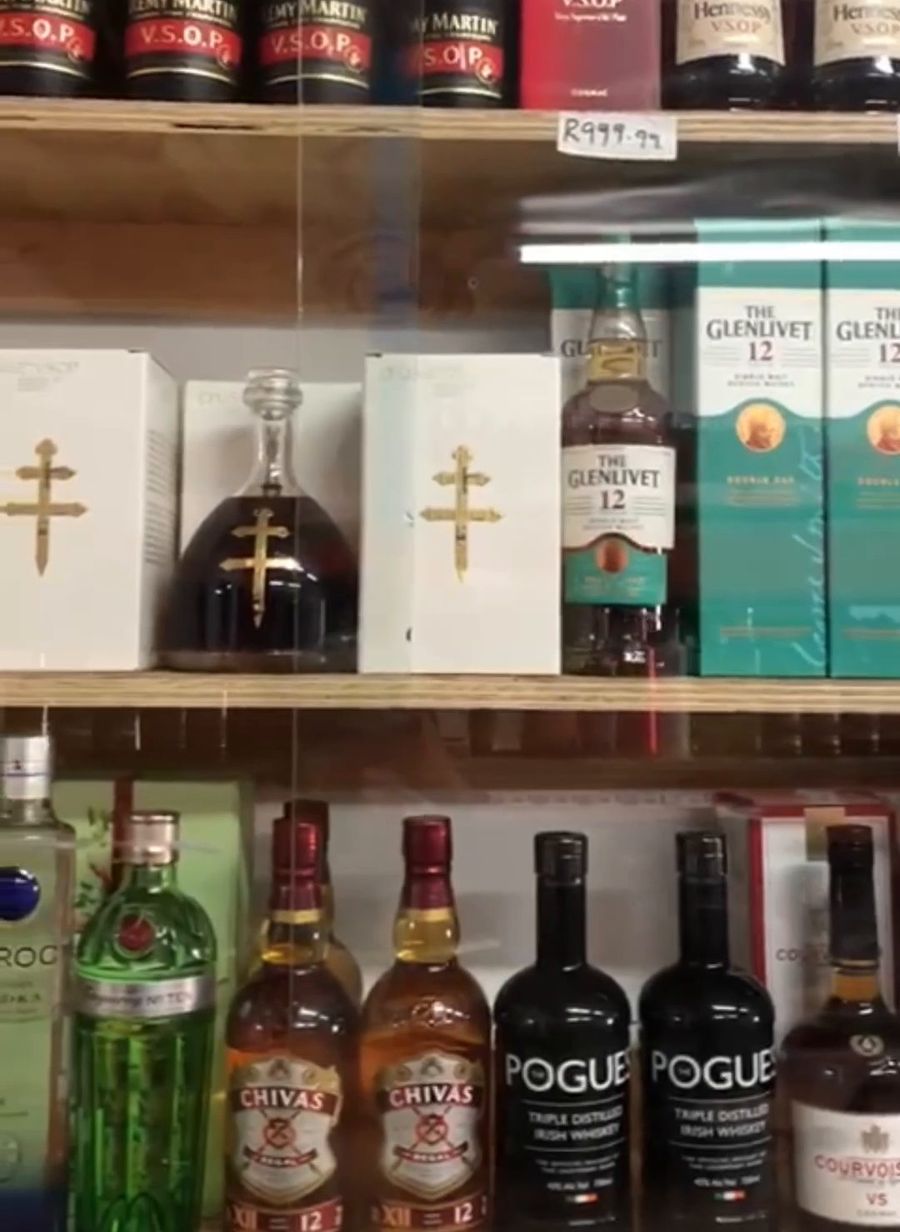 Premium whisky and cognac cabinet at Varsity Blue Bottle Liquors